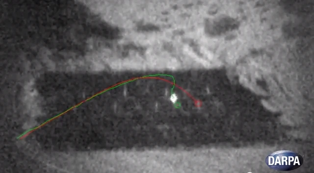 With the rifle intentionally aimed to the right of the marked target, the bullet can be seen veering in trajectory, altering its path to strike accurately over an undisclosed distance