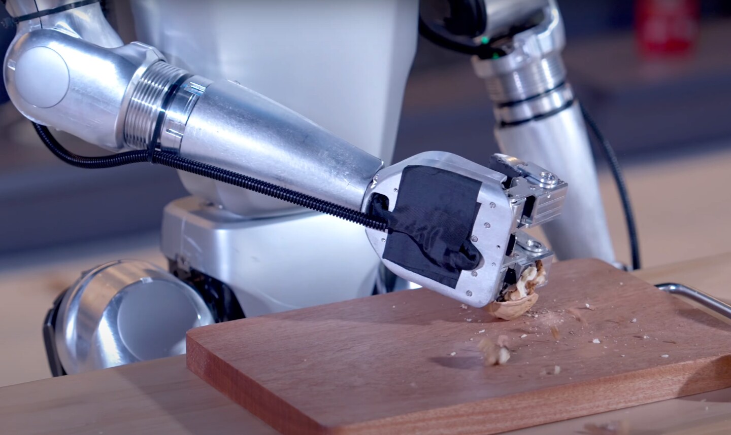 The G1 humanoid demonstrates its kitchen skills by bashing the hell out of innocent walnuts
