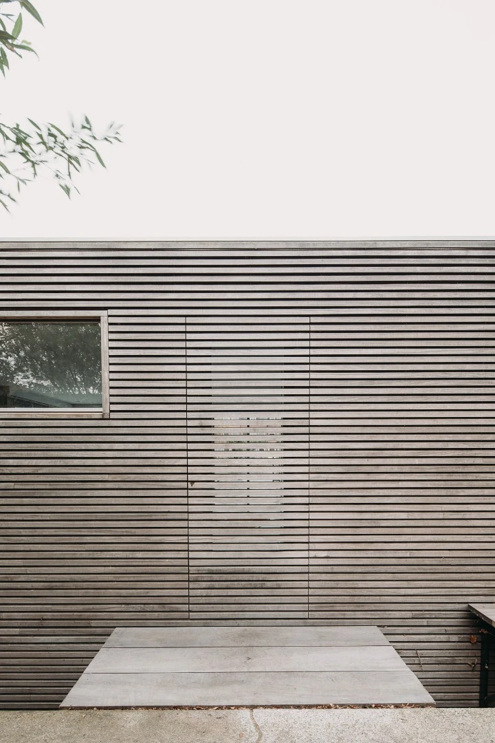 The floating home features a locally sourced wooden cladding façade