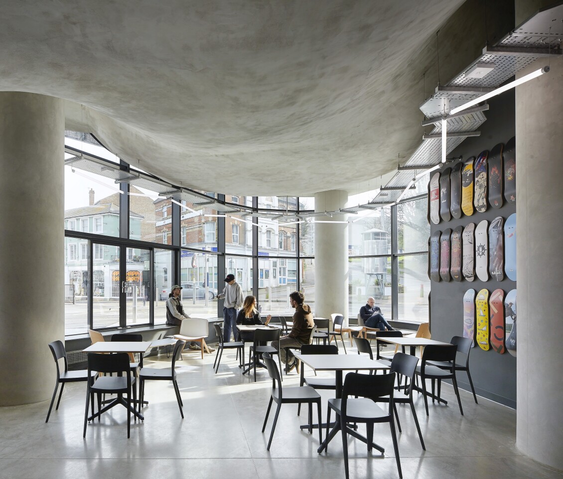 The underside of the second floor concrete skate bowl protrudes into the ceiling of F51's ground floor café space