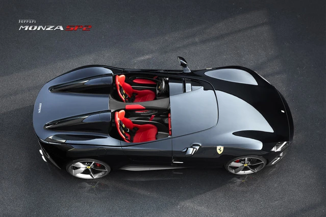 The Ferrari SP1 and SP2's front-hinged one-piece carbon fiber hood opens up to reveal a V12 engine