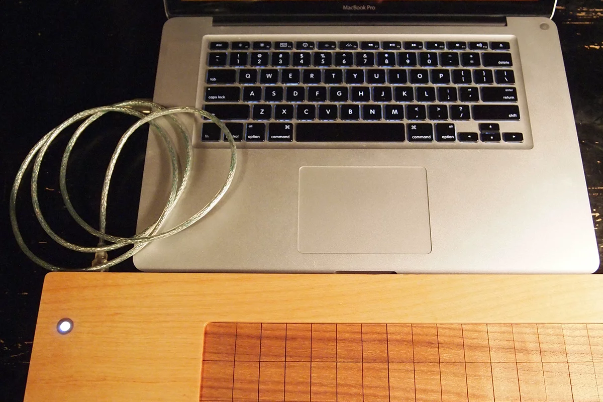 The Soundplane Model A computer music controller has a touch-sensitive walnut playing surface that can be played as 150 note keyboard or as one continuous surface