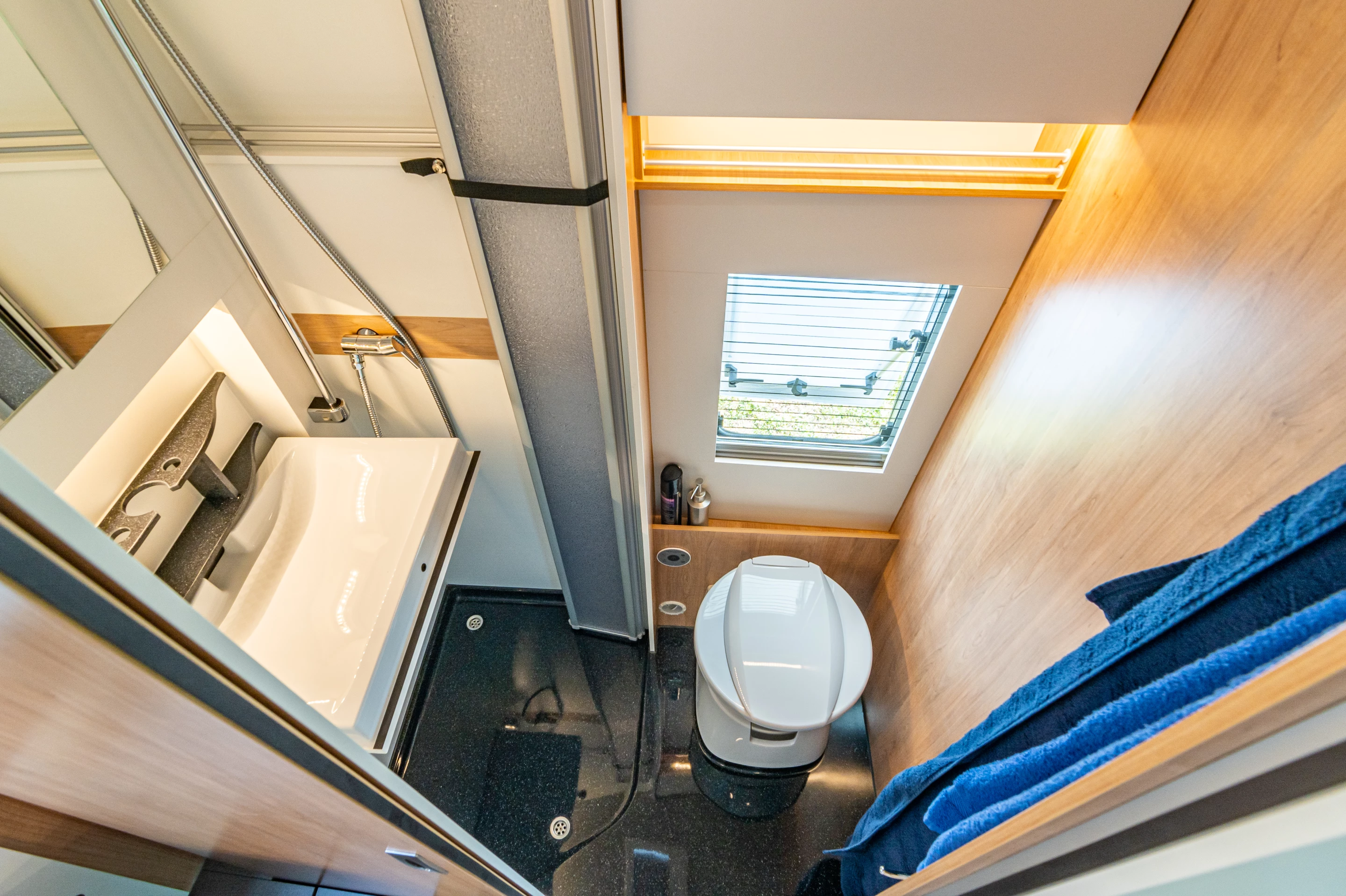 Using a foldaway sink, La Strada creates a compact dry bath with separate shower and toilet area