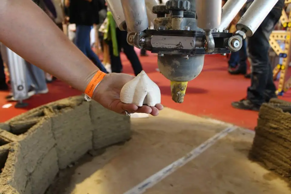 While not a full scale model on show at Maker Faire, at 4 m (13 ft) it was able to produce smaller versions of its mud brick dwellings and serve as a proof-of-concept