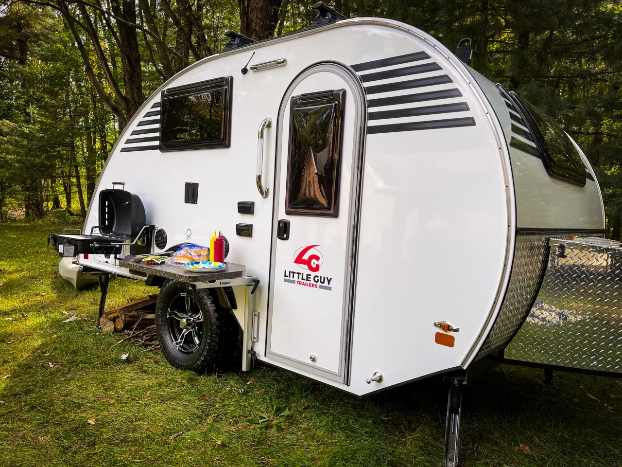 The all-new Little Guy Micro Max teardrop trailer comes with exterior attachments for a Lagun table and BBQ grill, creating an outdoor kitchen