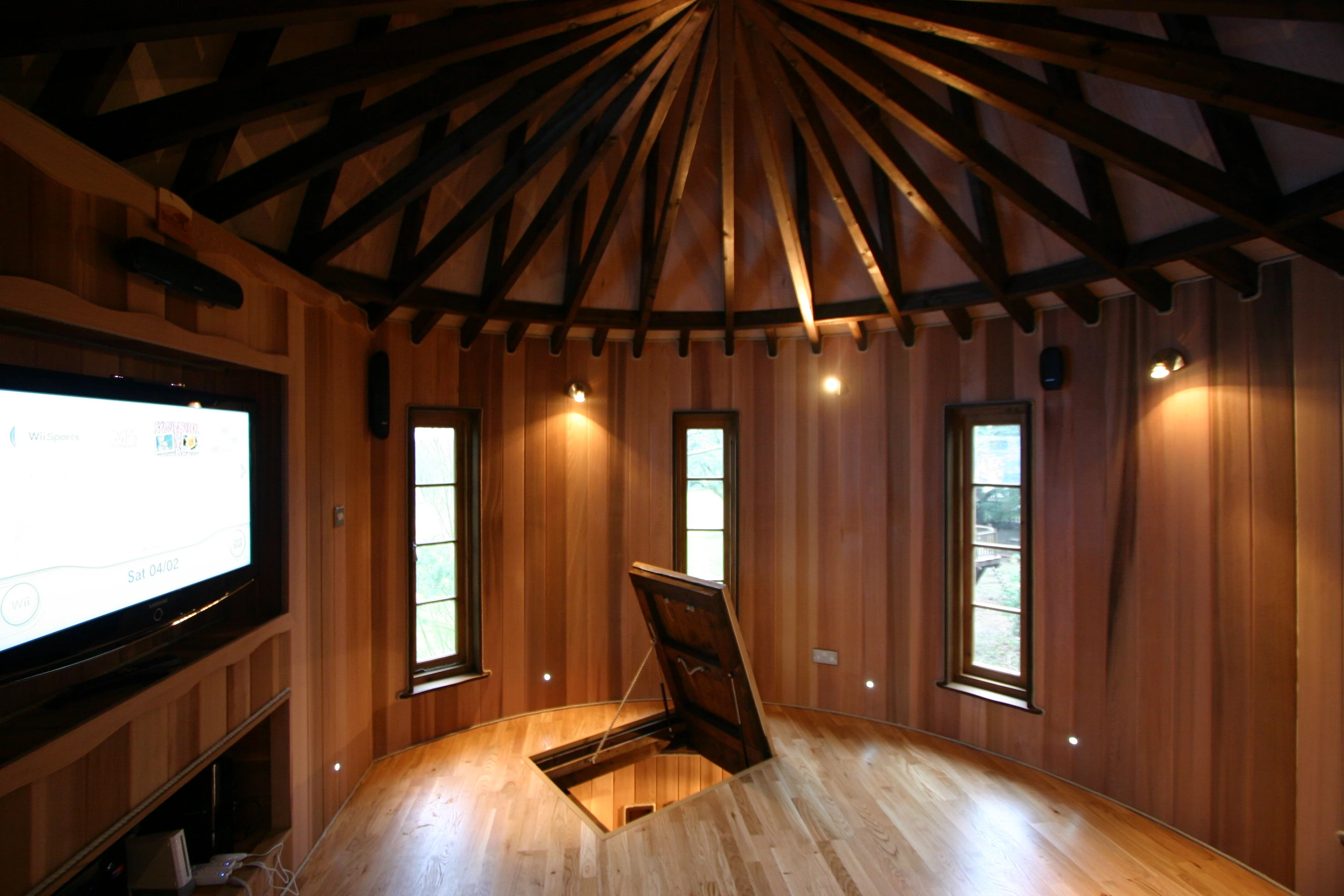 To indulge the treehouse fantasy, the kid's hideaway also features a secret trapdoor that leads into a games room