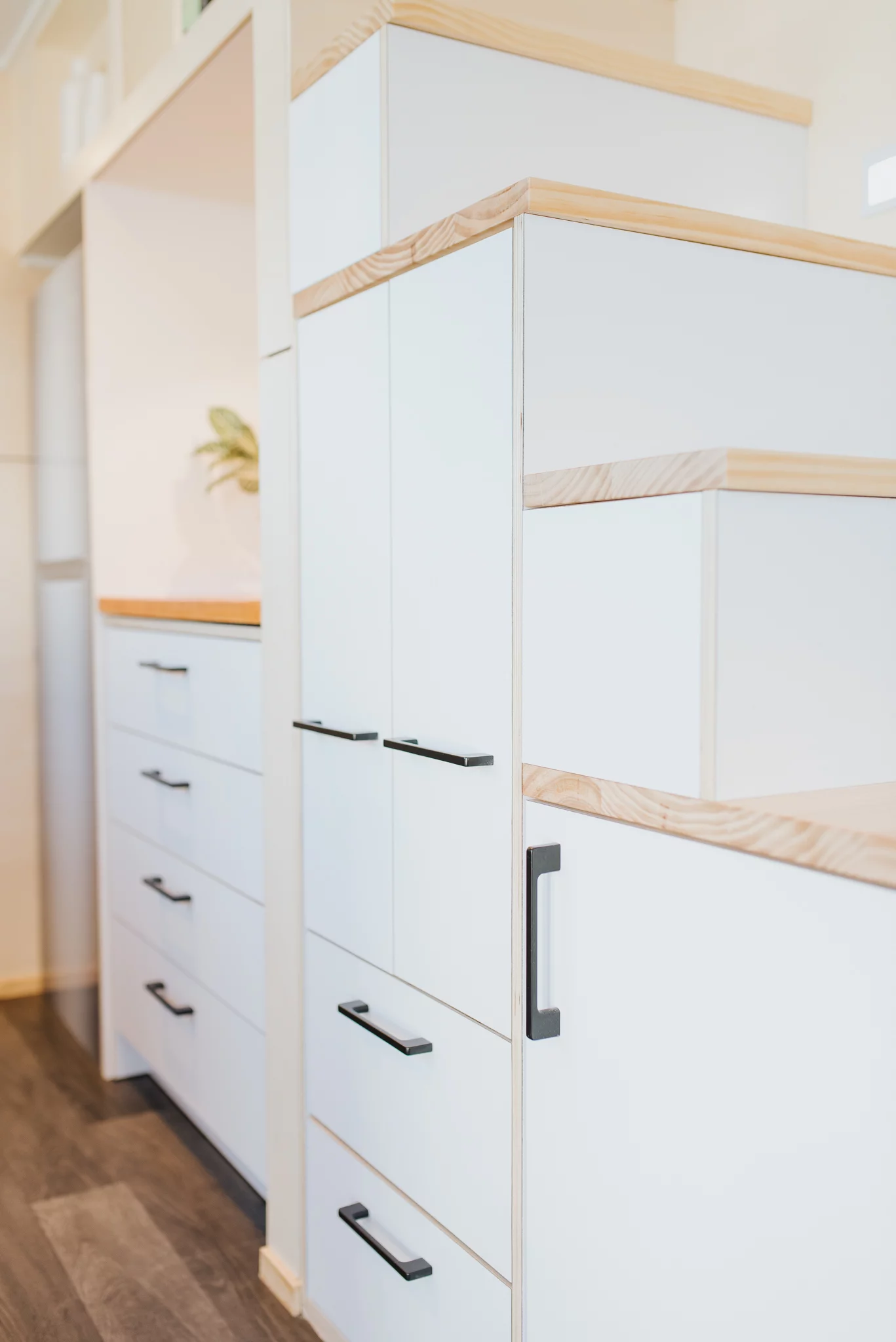 The Dreamweaver Tiny House has a storage-integrated staircase