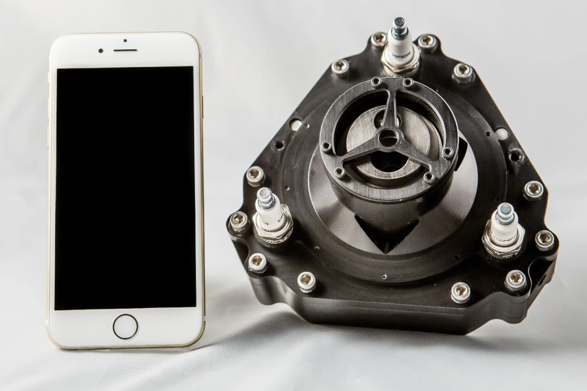This tiny engine, compared here to an iPhone, outputs almost 3.5 horsepower
