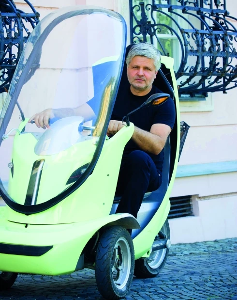 Designer Stefan Klein in his award winning three wheeled electric scooter, which he uses to commute to work each day (Photo: Peter Zakovic, SME)