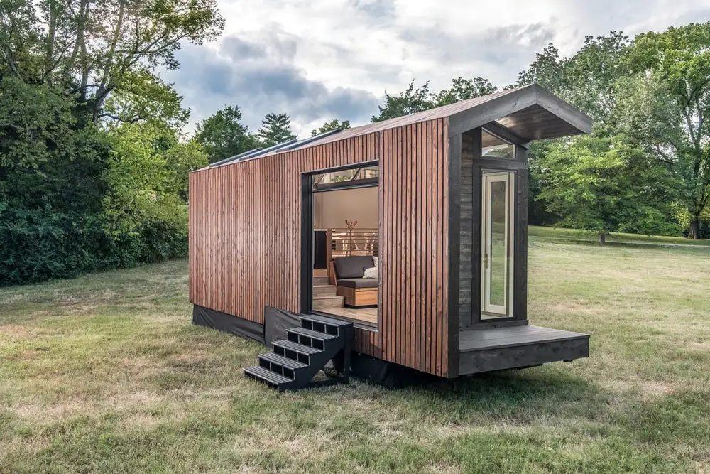 The Orchid Tiny House's trailer wheels are hidden behind a cover