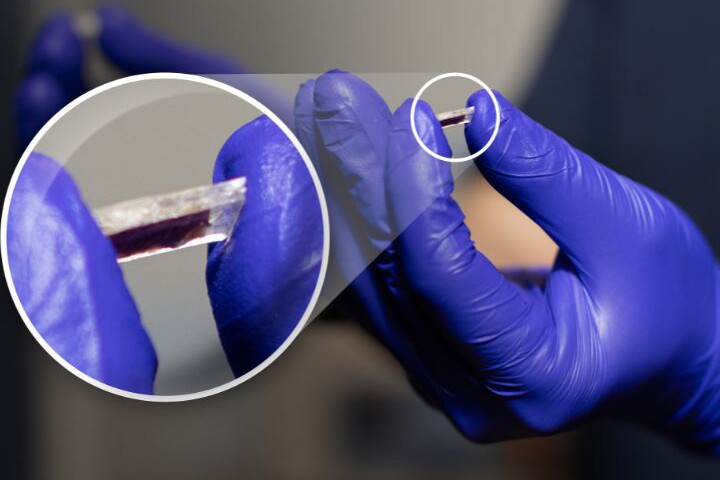 A University of Houston researcher holds a newly developed piezoelectric sensor that operates under extreme temperatures and harsh environmental conditions