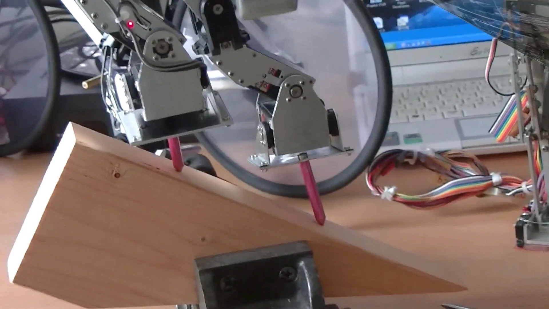 Close up: Dr. Guero's hobby robot kit balances on stilts on a 45 degree slope