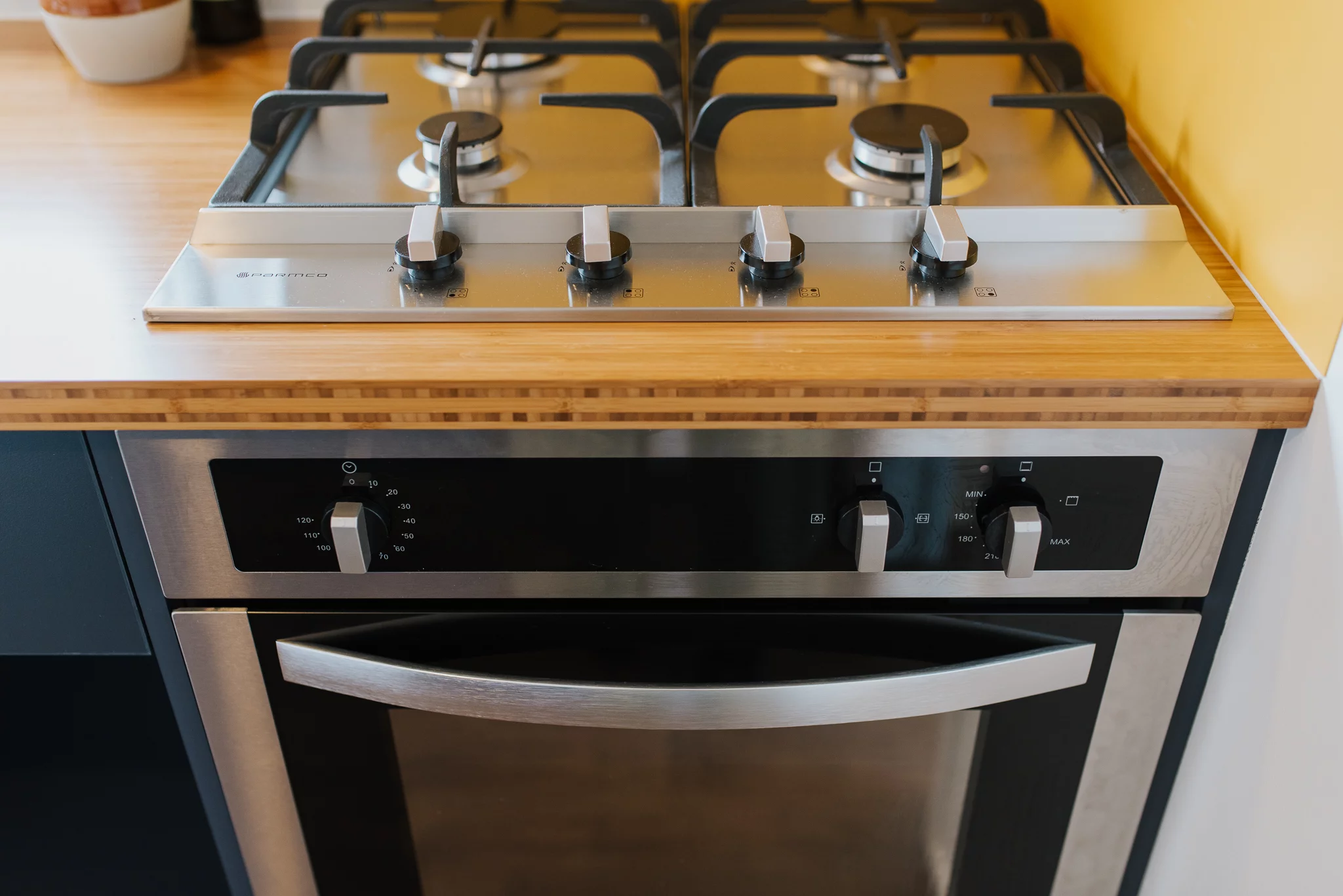 Cyril the Tiny House's kitchen features an oven with propane-powered four-burner stove