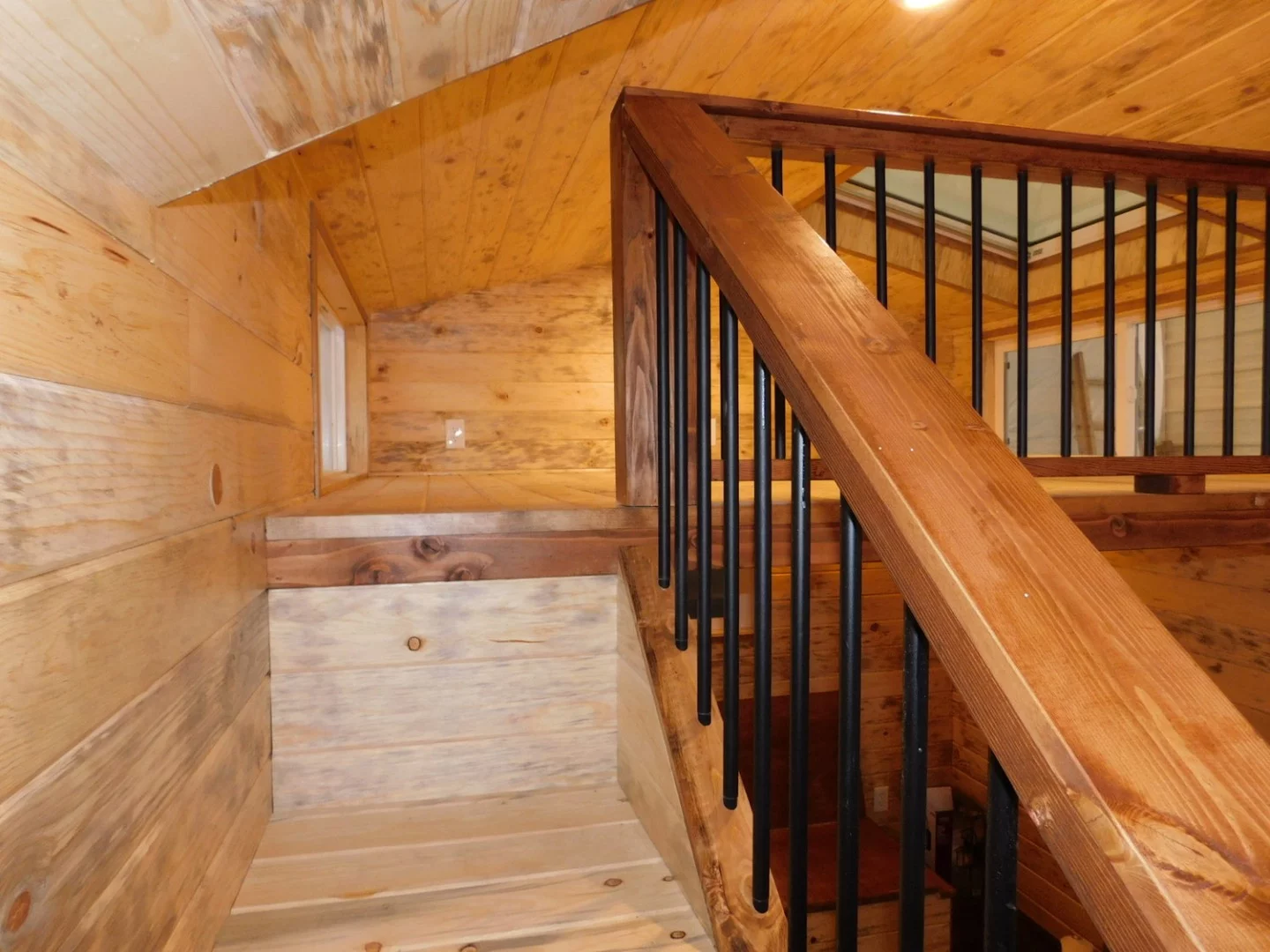 A "normal" staircase with bannister leads to the Purple Monster's loft bedroom