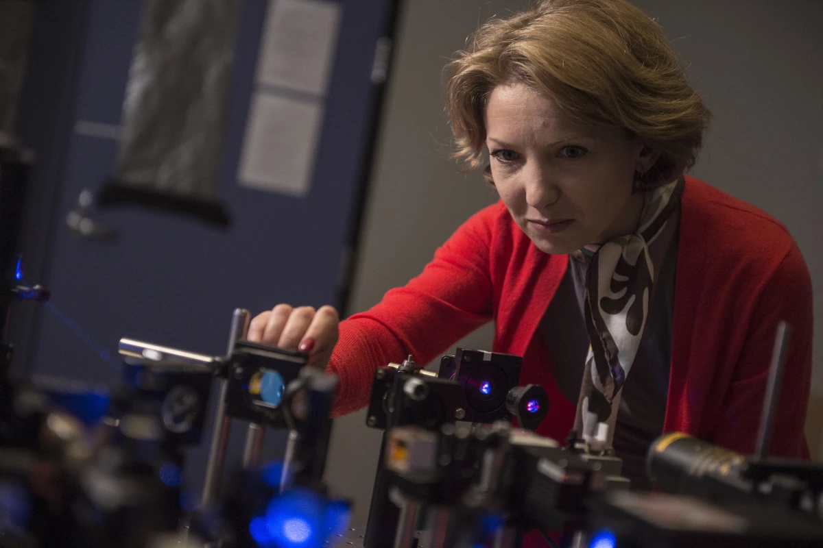 Rice University research scientist Ekaterina Lukianova-Hleb adjusts equipment used in experimentation on plasmonic nanobubbles. (Credit: Jeff Fitlow/Rice University)