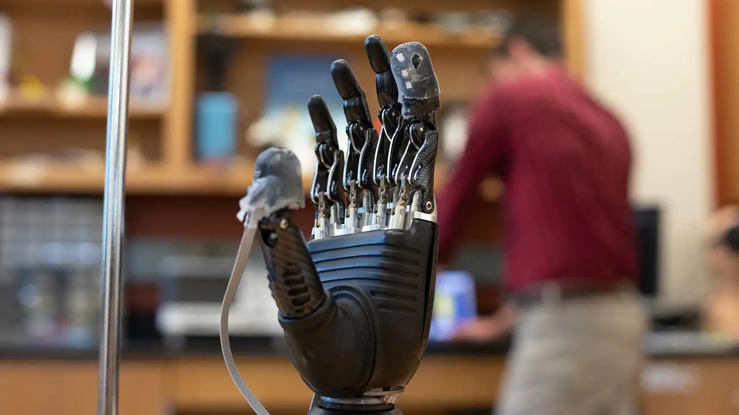 The "e-dermis" applied to the thumb and forefinger of a prosthetic hand