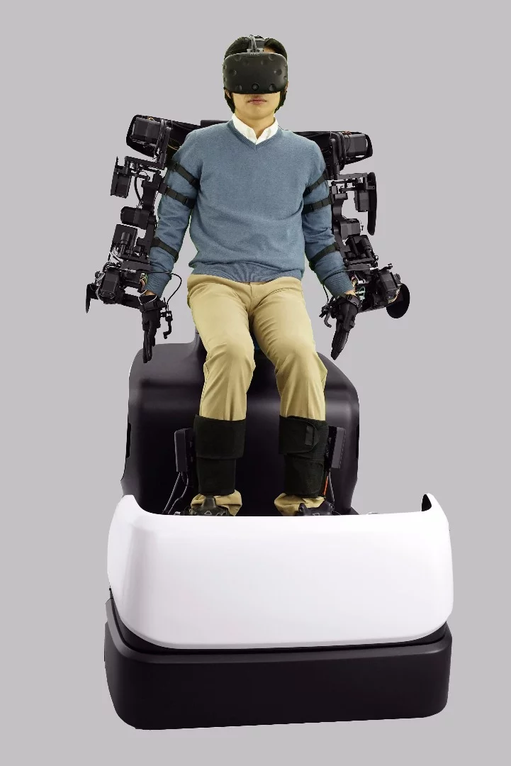 The operator seated in the Master Maneuvering System module has hand, arm and foot movements mapped and sent to the T-HR3 humanoid robot