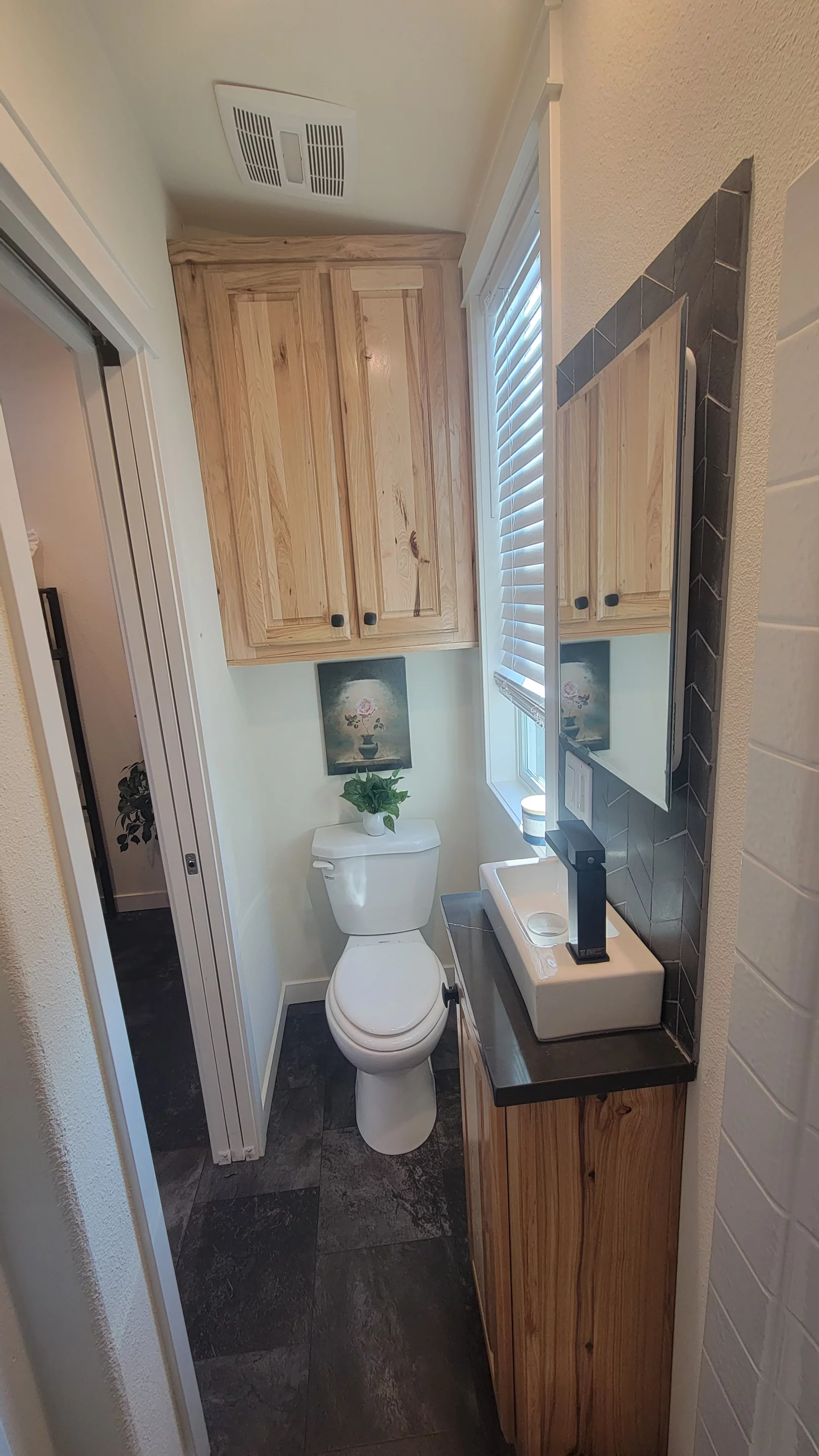 The Olivia Summit's two bathrooms are very similar and each includes a flushing toilet, a small vanity sink, and a shower