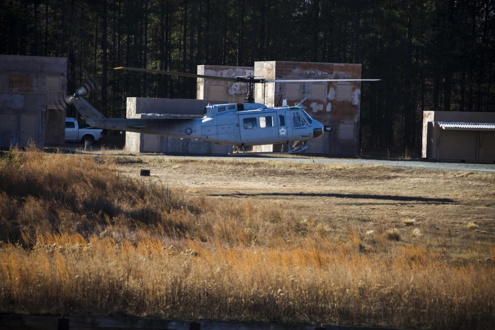 A Marine Corps Bell UH-1Y Venom lands using the Autonomous Aerial Cargo Utility System (AACUS) at Urban Training Center Marine Corps Base Quantico, Vairginia