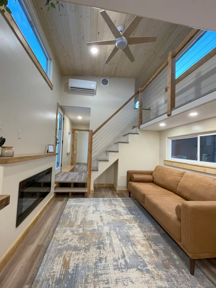 The Perpetua's living room is pictured here with a standard sofa, but a sofa bed would need to be installed to increase its sleeping capacity to eight people