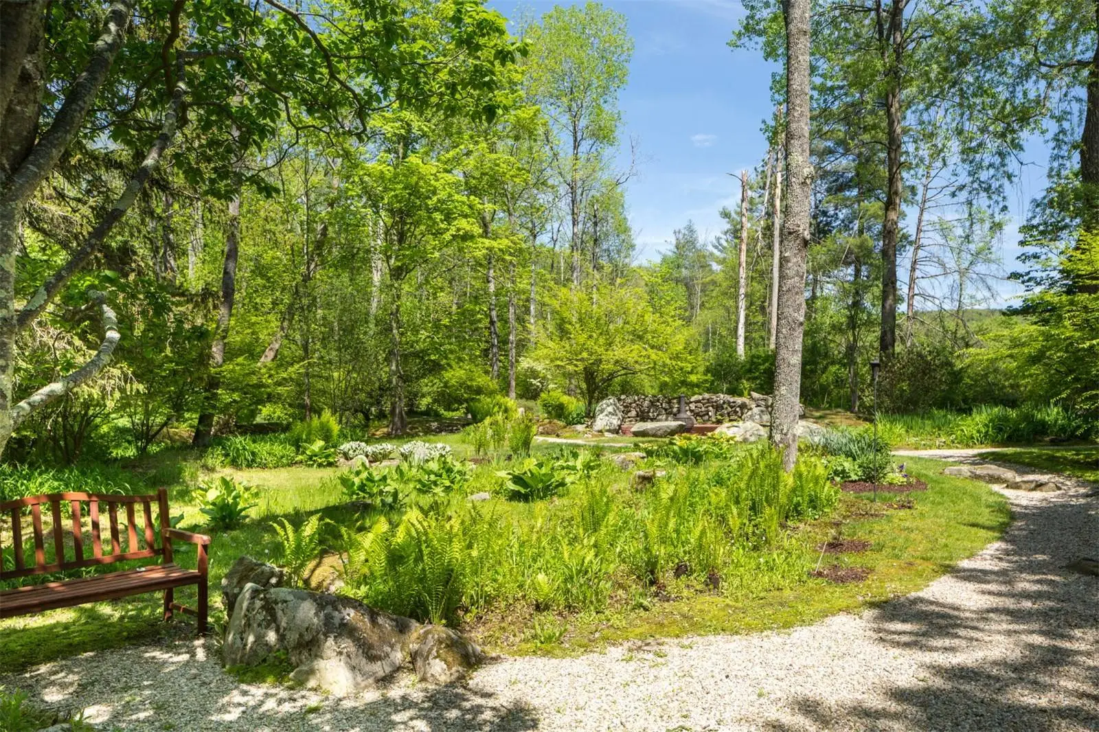 The four acre landscaped gardens surrounding the Tyringham Gingerbread House estate boast bridges, brooks and blossoms