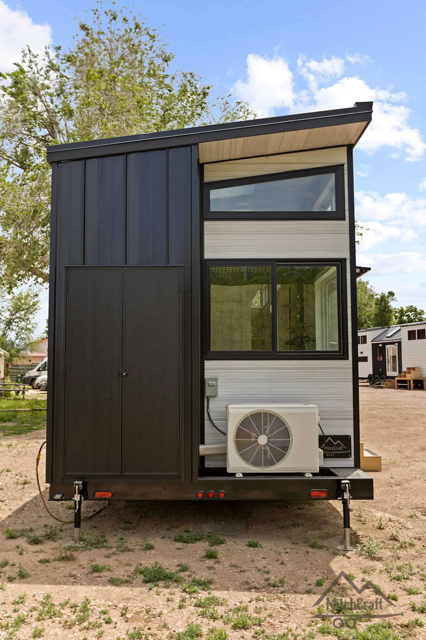 Casey's 32' x 10' Tiny Home gets power from a standard RV-style hookup and features an air-conditioning system for heating and cooling, plus underfloor heating