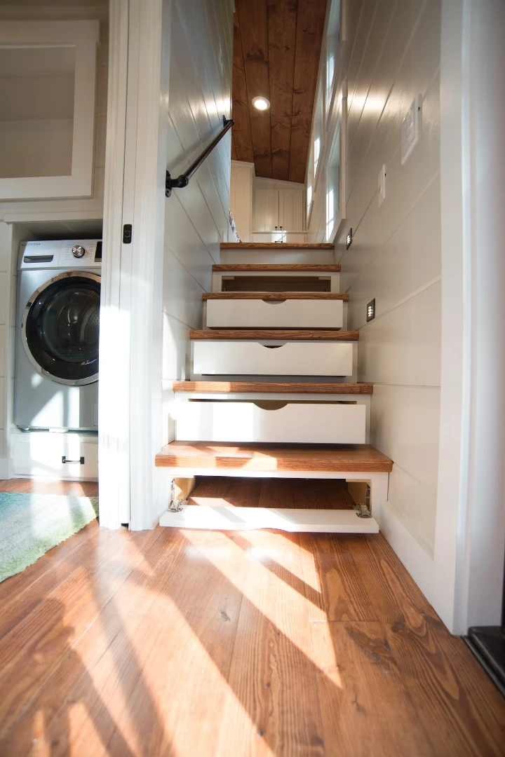 The Retreat's master bedroom is accessed by storage-integrated staircase