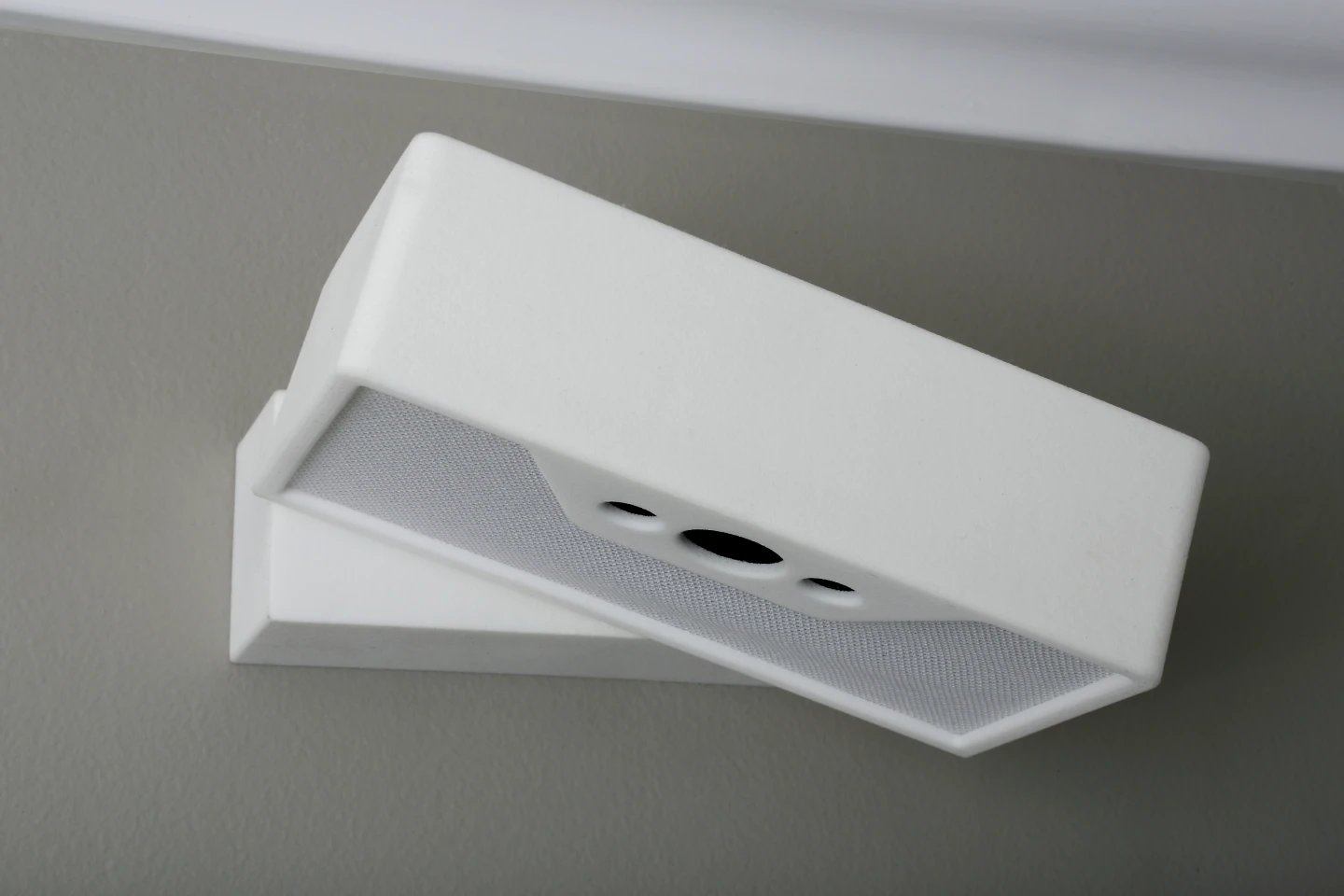 The white-brick-shaped box is attached to a wall mount above the user's bed (Photo: Lucera Labs)