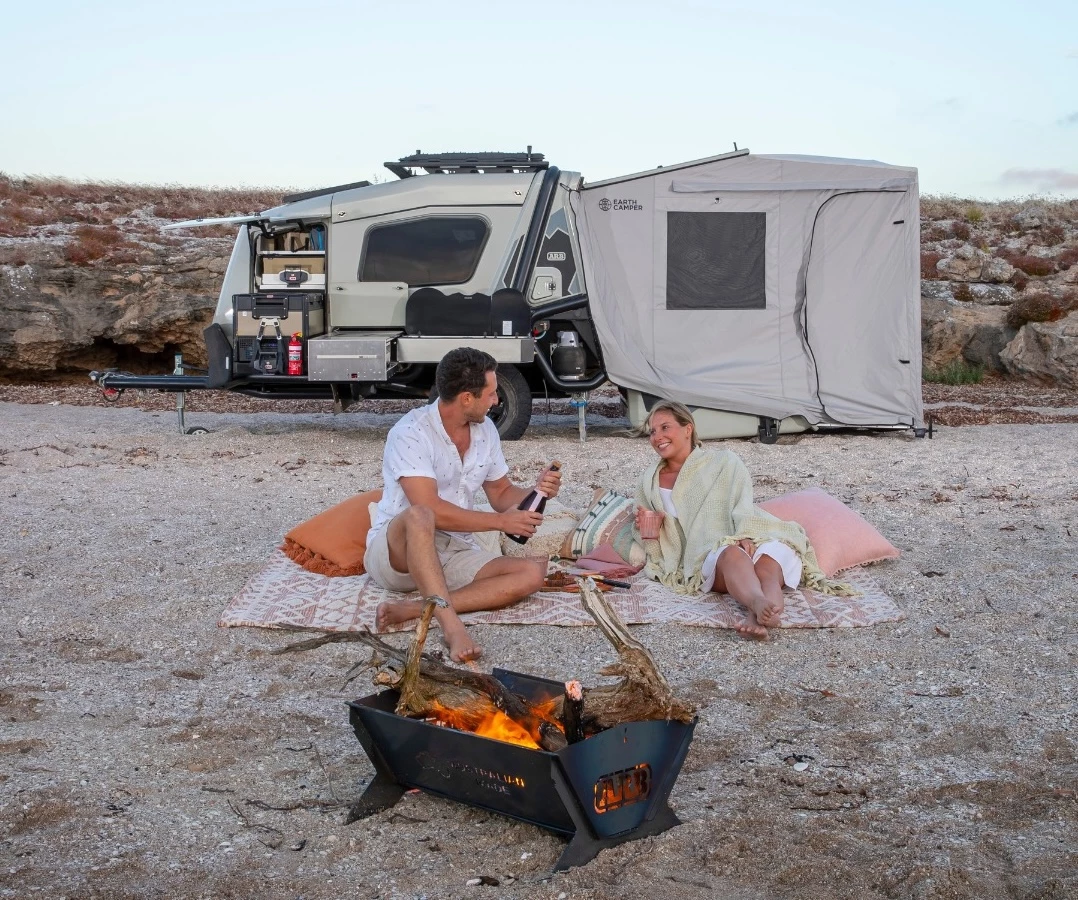 Enjoying the camping comfort provided by a meticulously engineered and equipped base camp trailer