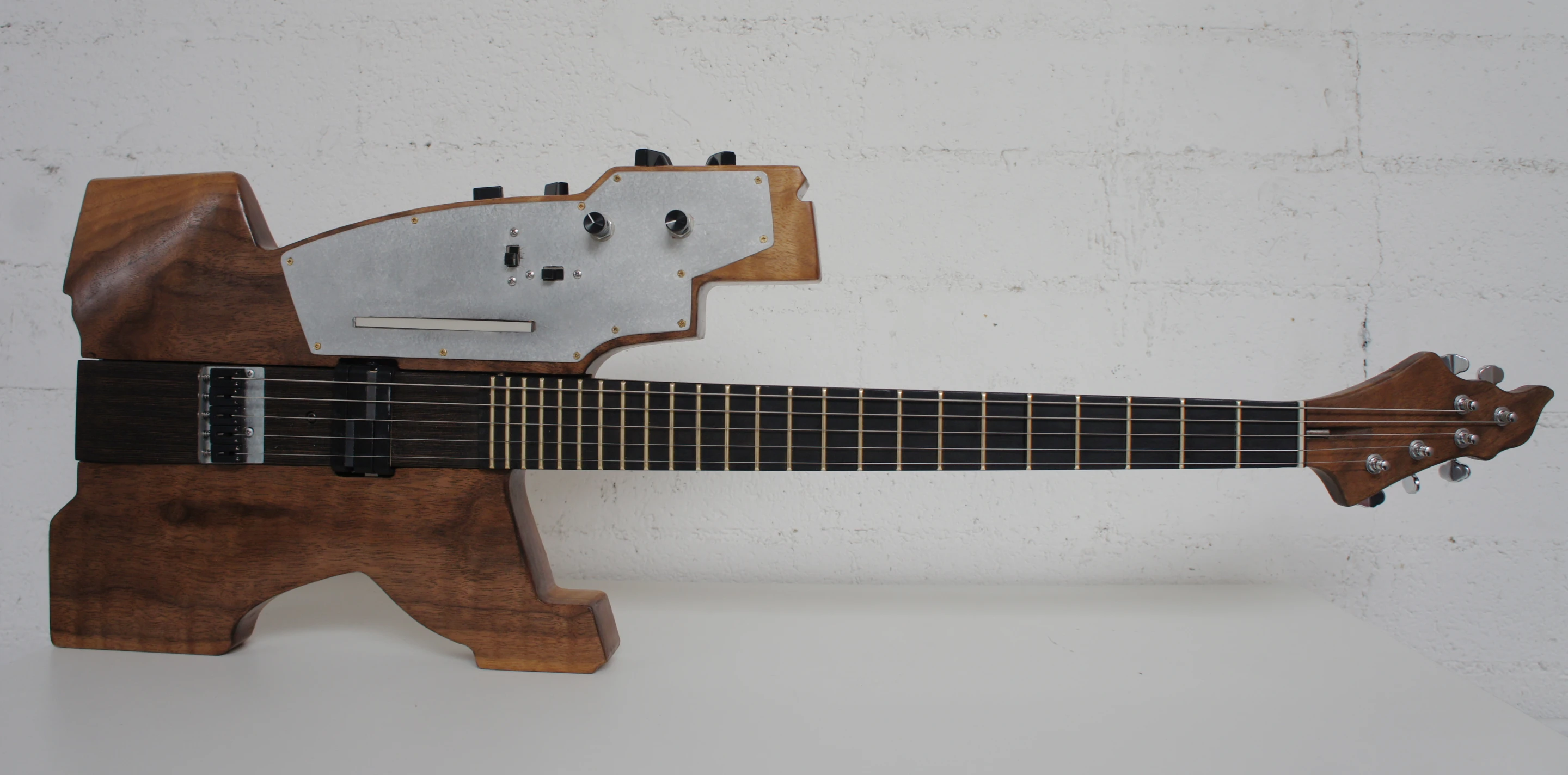Front view of an assembled 5-string kitar, showing the membrane potentiometer on the upper wing of the solid walnut body