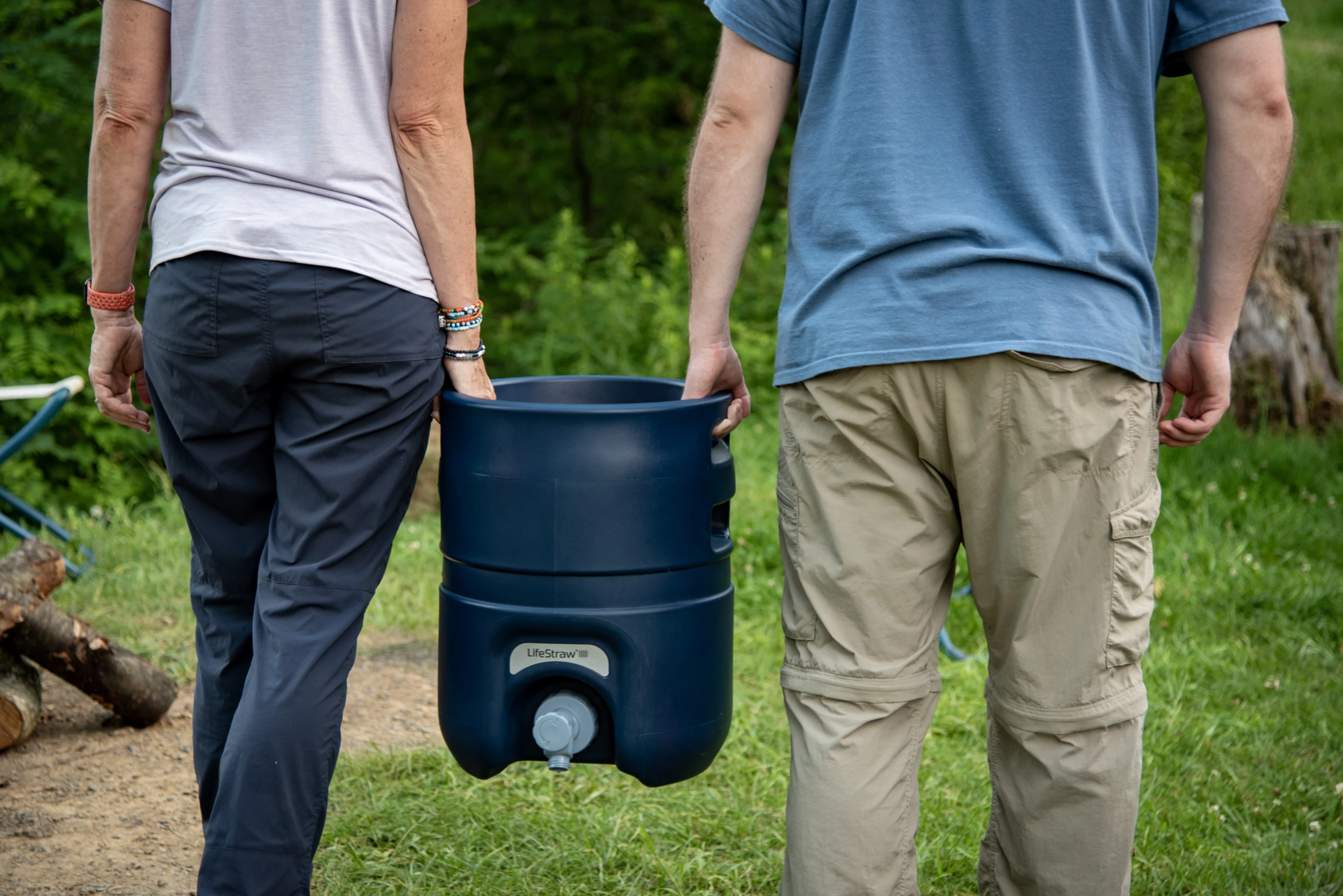 Water weighs roughly 8 1/3 lb per gallon, and the Escape itself weighs 16 lb, totaling over 59 lb - so carrying it in twos will help ease the burden
