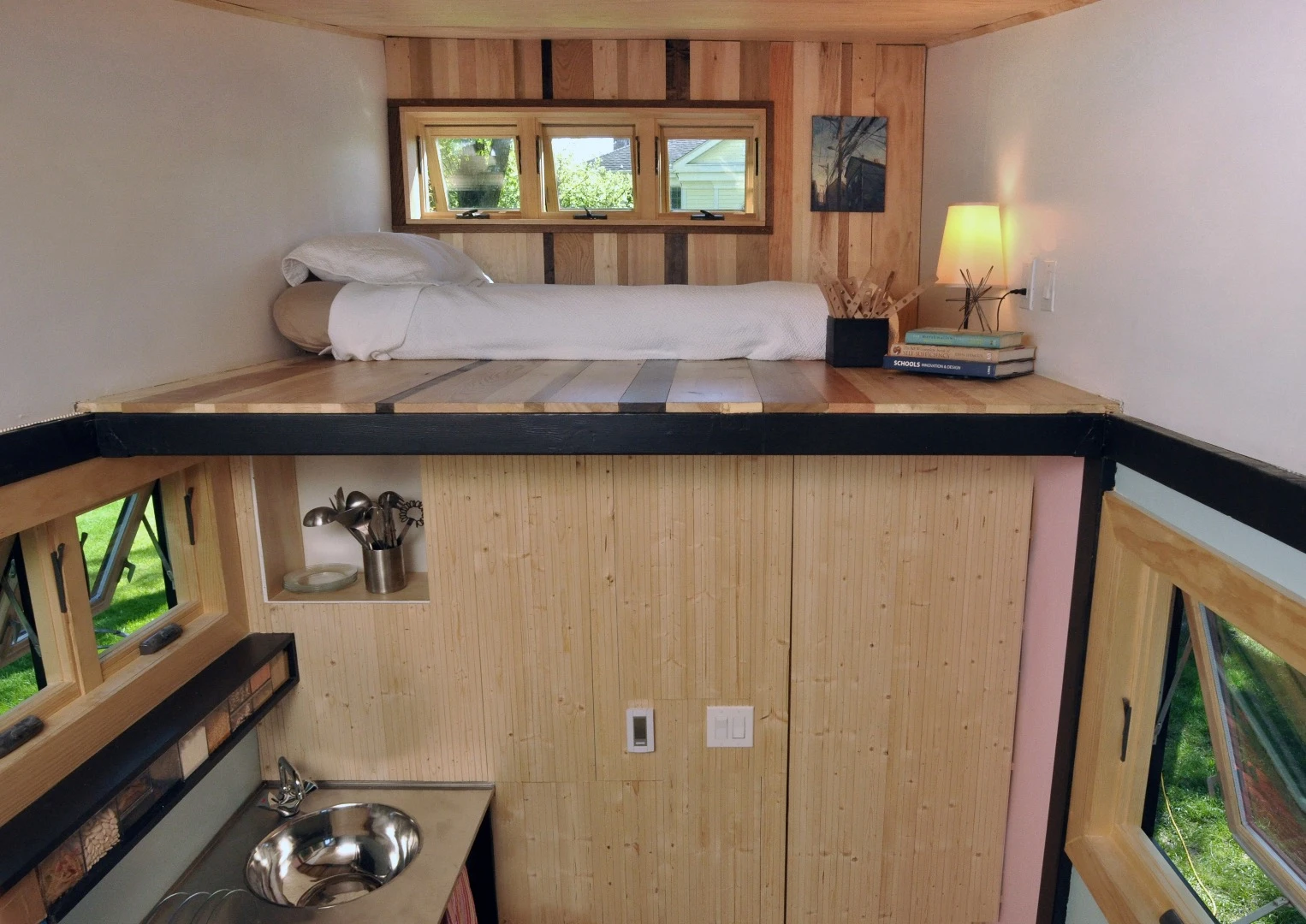 The primary sleeping area is a raised loft space accessible via moveable ladder