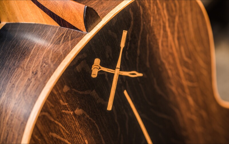 The Bushmills x Lowden F-50 features a cross symbol on the back that's formed by a copper's hammer and a luthier's chisel