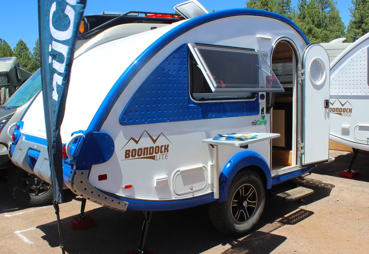 Available on both Tag and Tab models, the Boondock package is nüCamp's off-road kit with off-road wheels, pitched axle, Yakima roof rack and other upgrades aimed at rougher off-pavement driving/camping. That extra little lift at the tip of the rear overhang provides for a better departure angle versus the flatter edge found on some other models