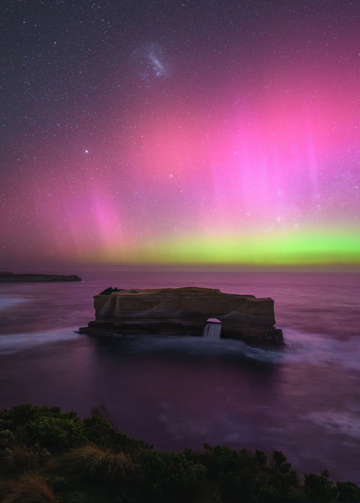 Bakers Oven Aurora Australis by Josh Beames, taken on the Great Ocean Road, Australia. Bright colors dance above a rock formation called Baker's Oven on the southern Australian coast