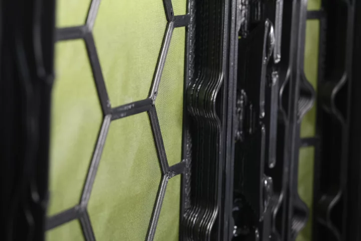 Each panel consists of the fabric base (green) and the 3D-printed structural grid (black)