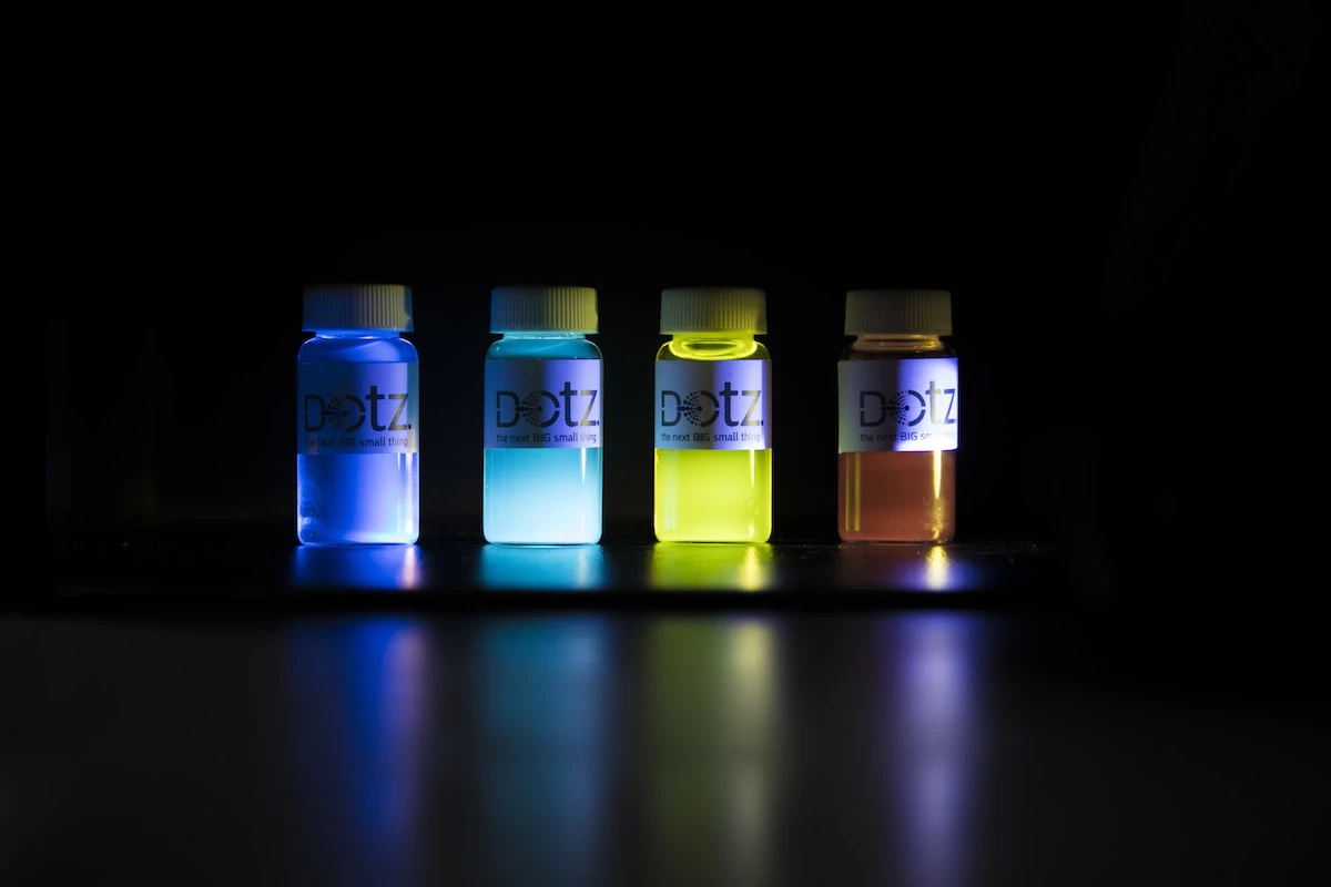 Quantum dots are semiconducting particles that absorb UV light and emit visible light, and the color is controlled by the size of a given dot