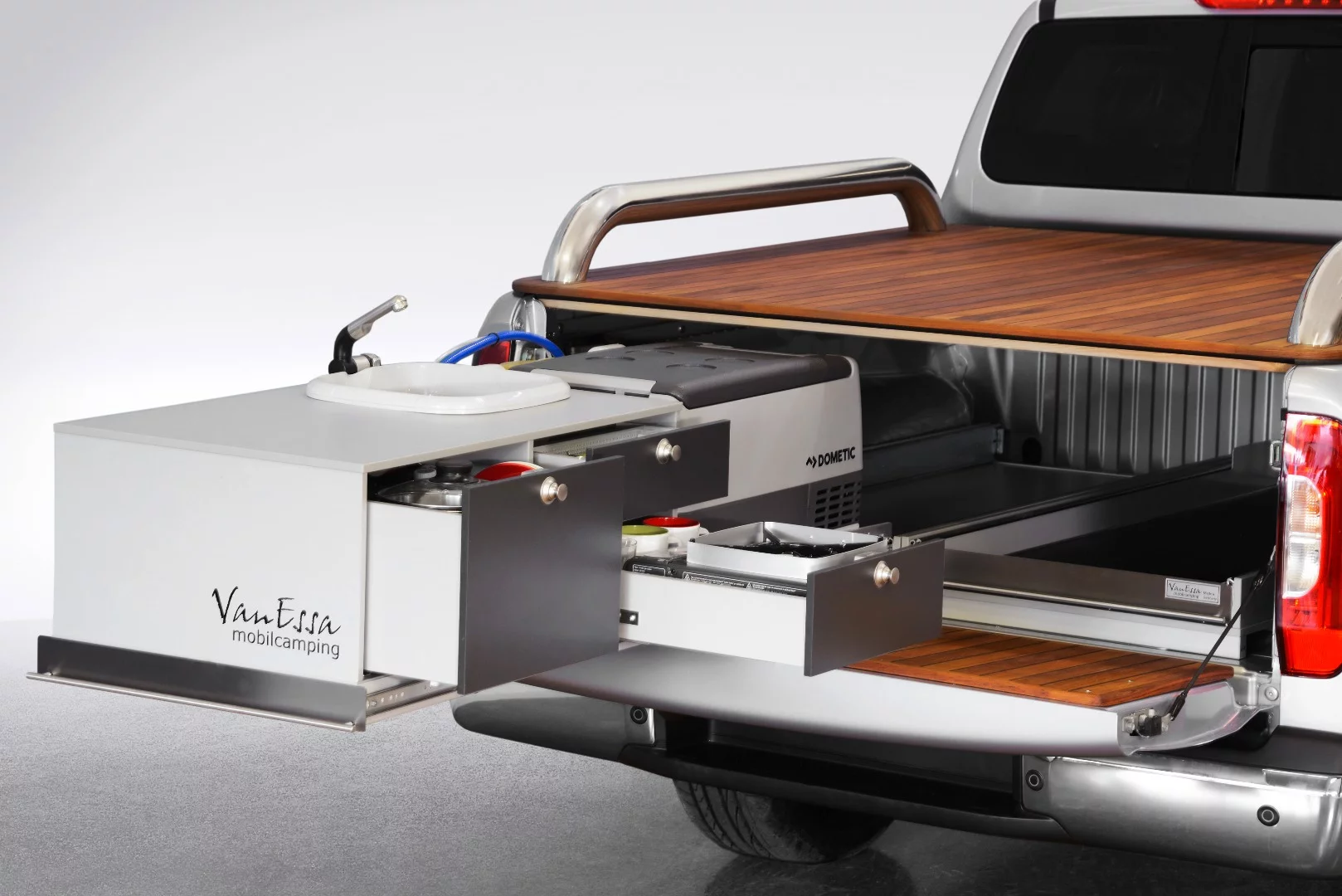 VanEssa's slide-out system includes a full kitchen, general storage and an elegant wood cover