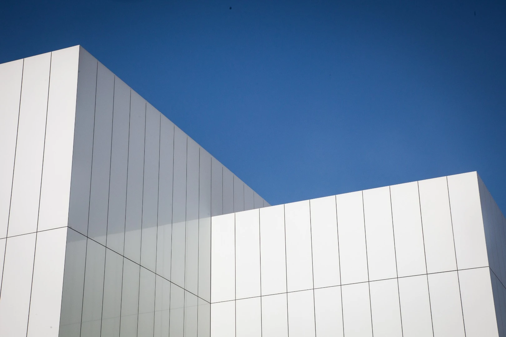The Jameel Arts Centre concrete and semi-reflective aluminum cladding is intended to shimmer ever so slightly in response to the surrounding water