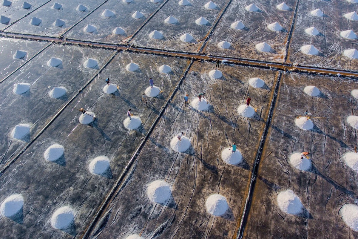 Workers ply their trade on the salt fields of Bac Lieu in the Mekong Delta, Vietnam