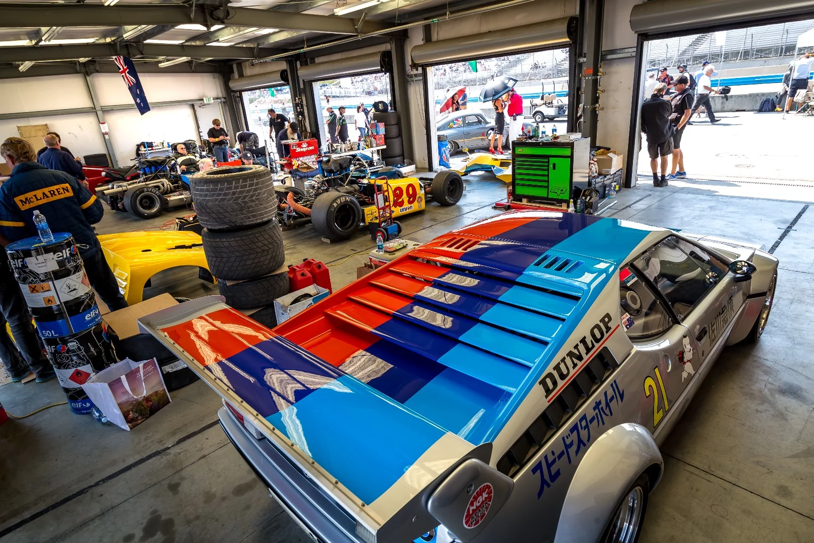 A BMW M1 race-spec car in the garage