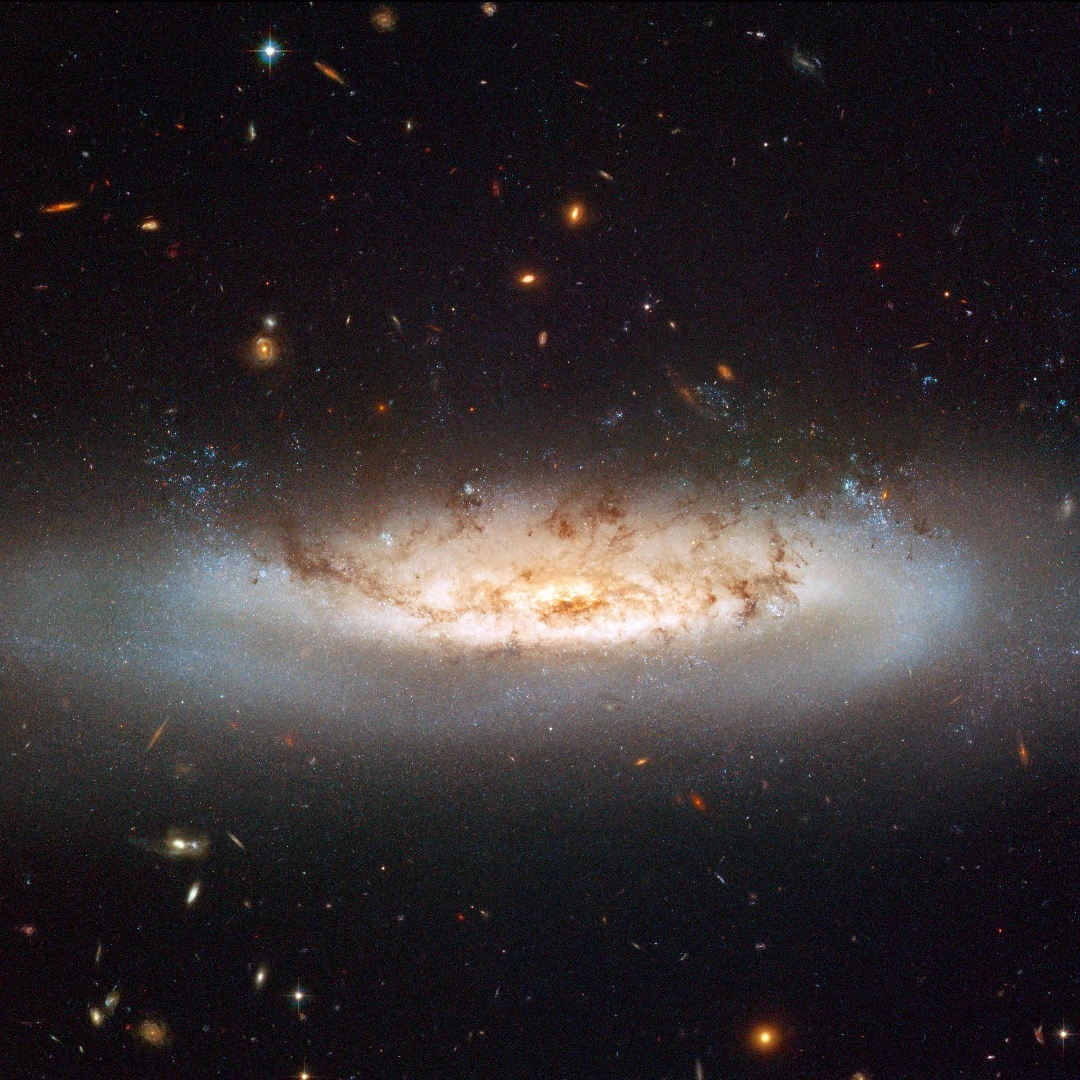 NGC 4522 is a spectacular example of a spiral galaxy that is currently being stripped of its gas content. The galaxy is part of the Virgo galaxy cluster and its rapid motion within the cluster results in strong winds across the galaxy as the gas within is left behind. Scientists estimate that the galaxy is moving at more than 10 million kilometres per hour