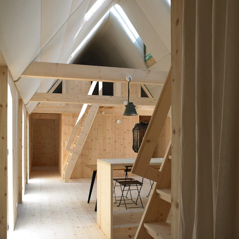 Modern Seaweed House features raw wooden interior furnishings