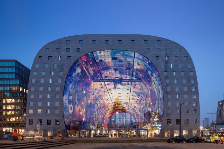 Rotterdam's new market hall, Markthal, is a huge arch that houses residential apartments