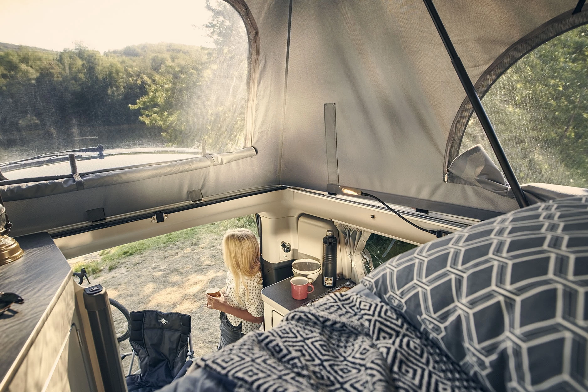 The soft-sided pop-up roof with windows creates an airier, more scenic upper bedroom versus the hard-walled high roof