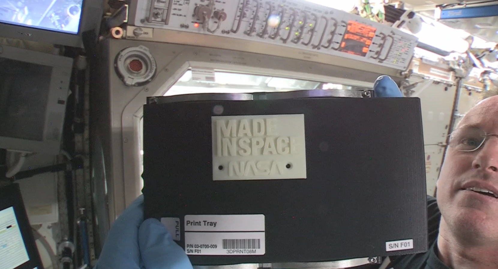International Space Station Commander Barry “Butch” Wilmore with the first object made in space by 3D printing (Image: NASA)