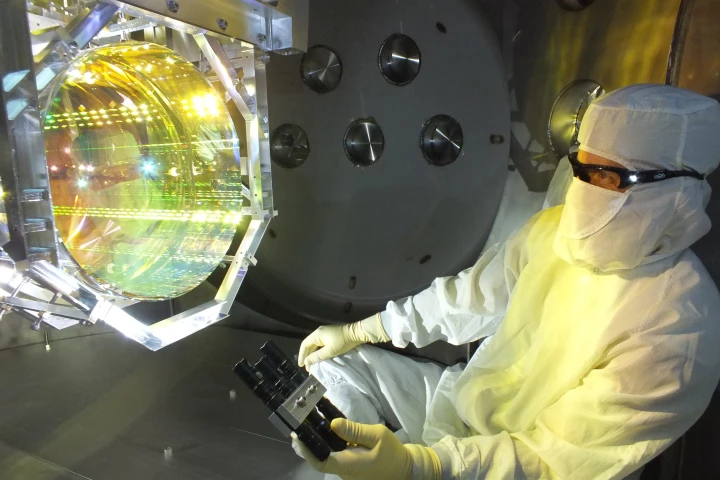 A scientist inspecting one of LIGO's mirrors, which has now been measurably affected by quantum fluctuations