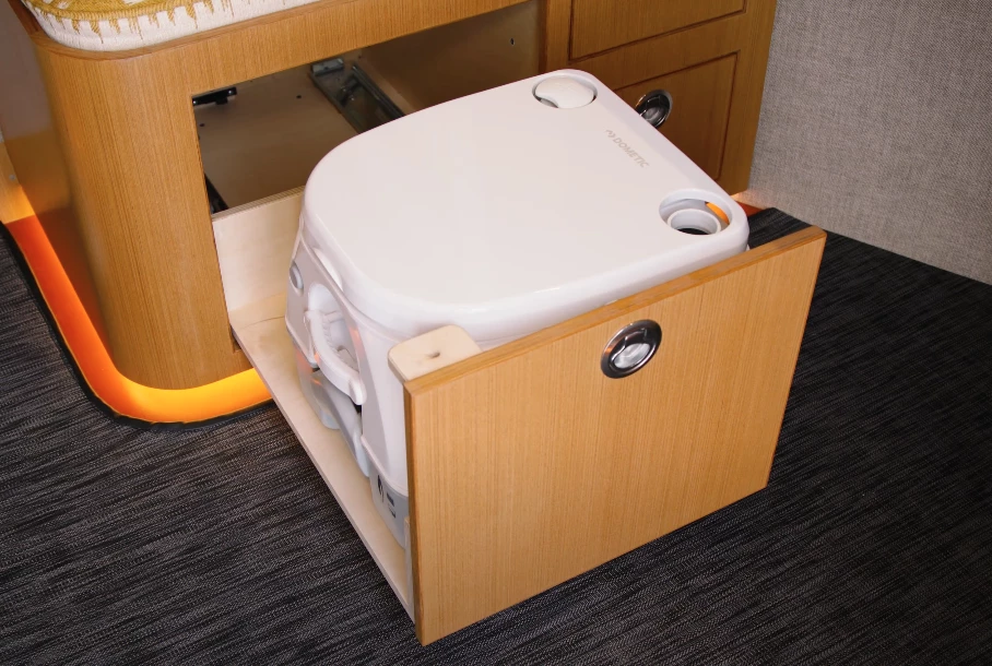 The toilet hides away below the dining bench