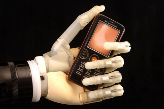 The iLimb hand, from Touch Bionics, demonstrating its ability to conform its grip to suit irregular objects.
