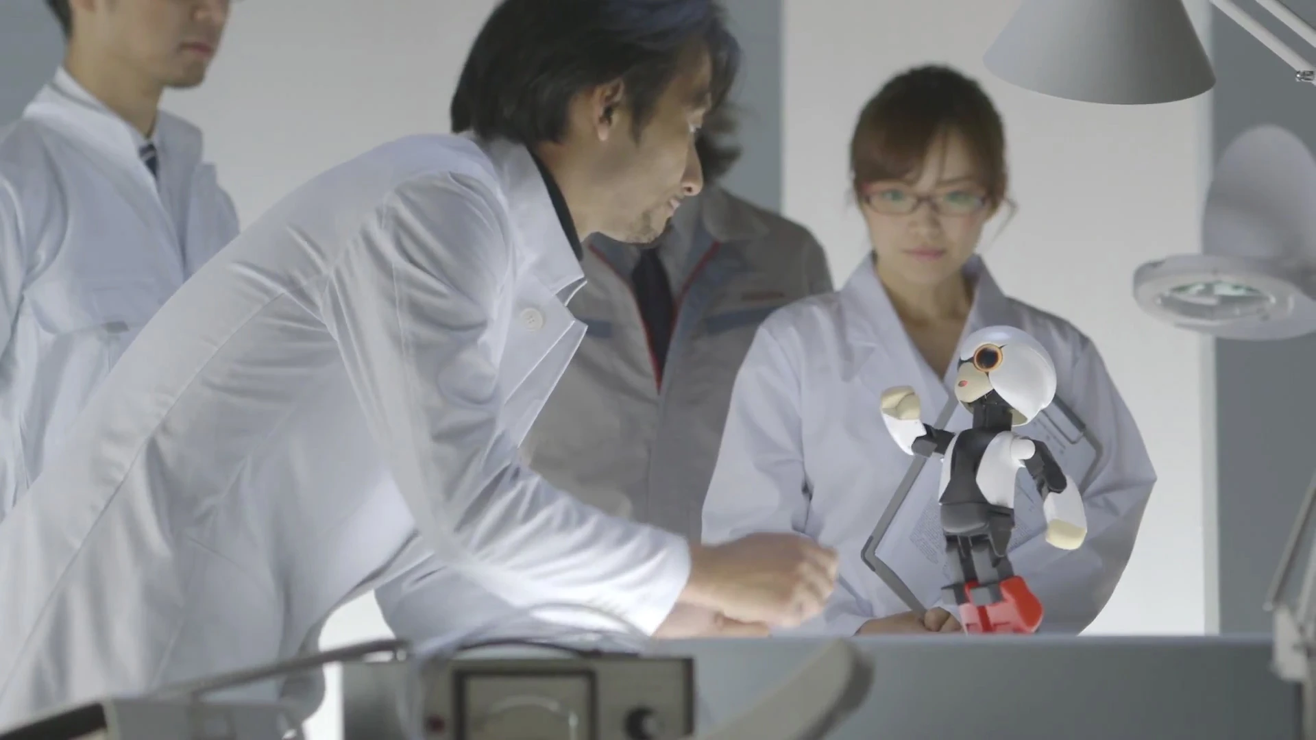 Kibo poses with its creator, Tomotaka Takahashi (front left)